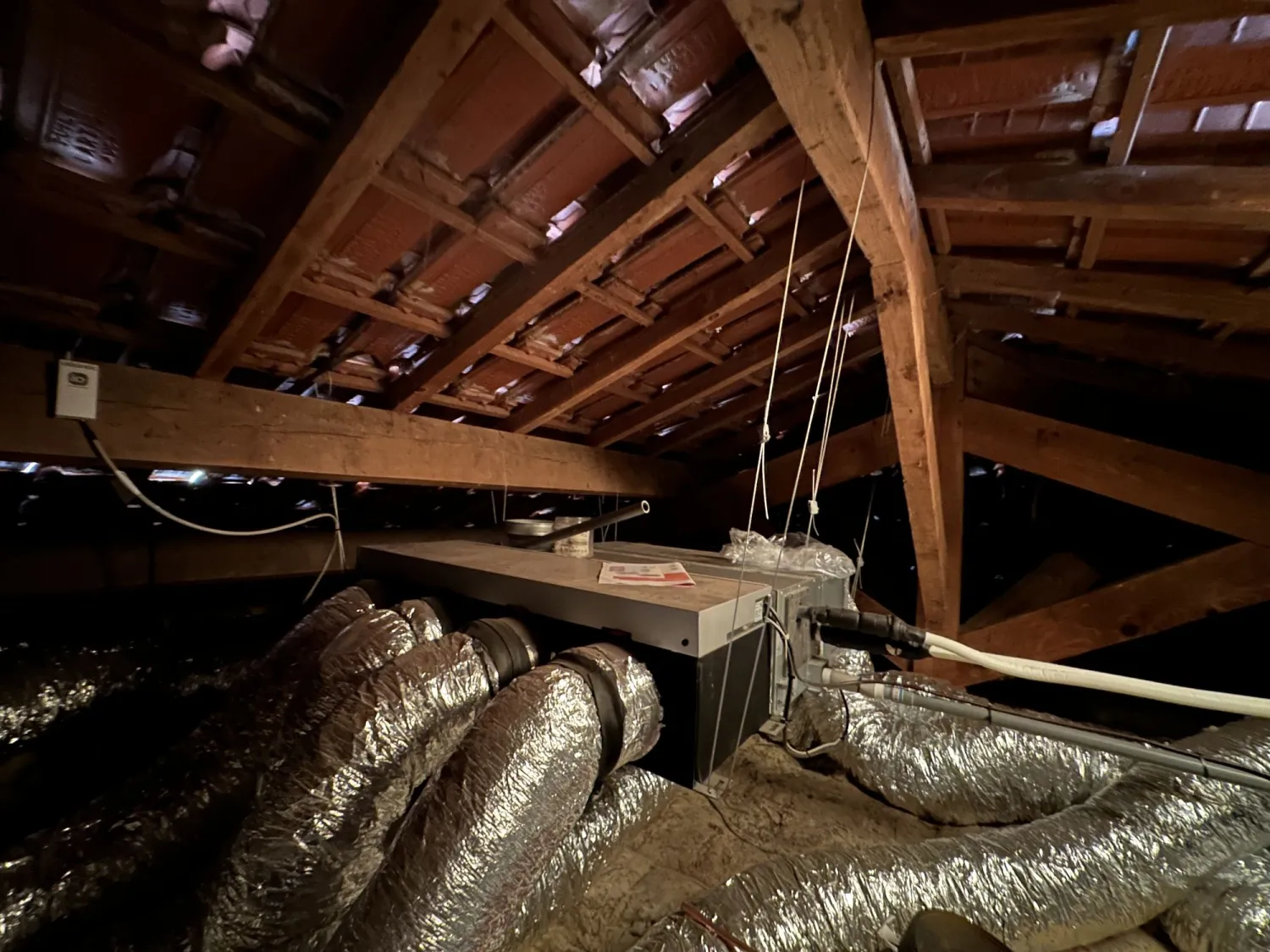Caisson et gaines d'une climatisation gainable installés dans les combles
